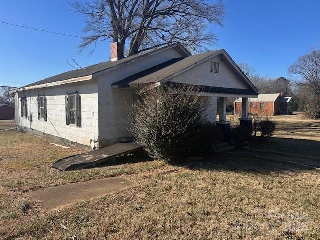 view of side of property with a lawn