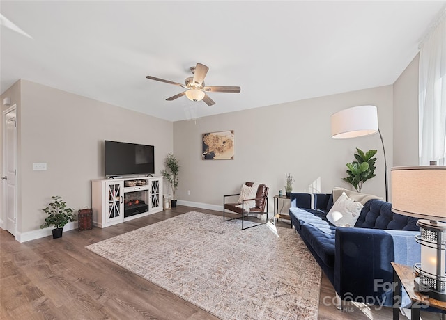 living room featuring wood-type flooring and ceiling fan