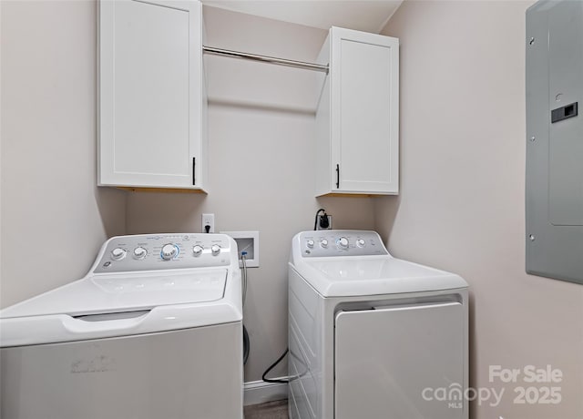 laundry area with cabinets, electric panel, and washer and clothes dryer