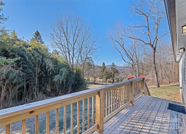 wooden deck featuring a yard