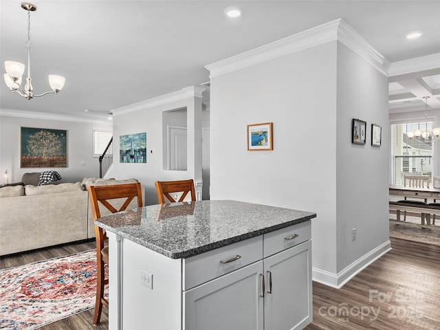 kitchen with a center island, decorative light fixtures, a notable chandelier, open floor plan, and a kitchen breakfast bar