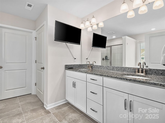 bathroom with double vanity, a sink, visible vents, and a shower stall