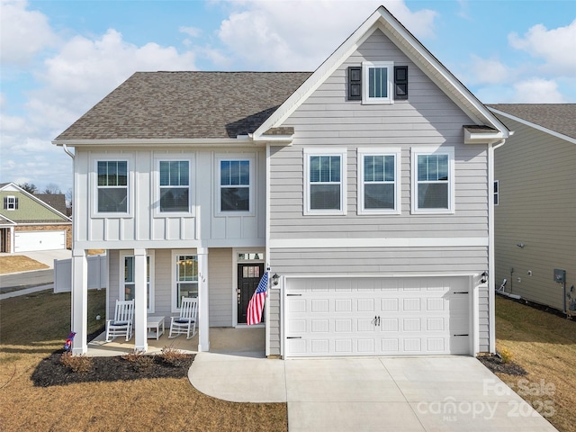 view of front of house featuring roof with shingles, a porch, an attached garage, board and batten siding, and driveway