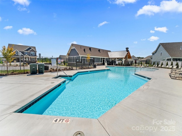 pool featuring a patio area, a residential view, and fence