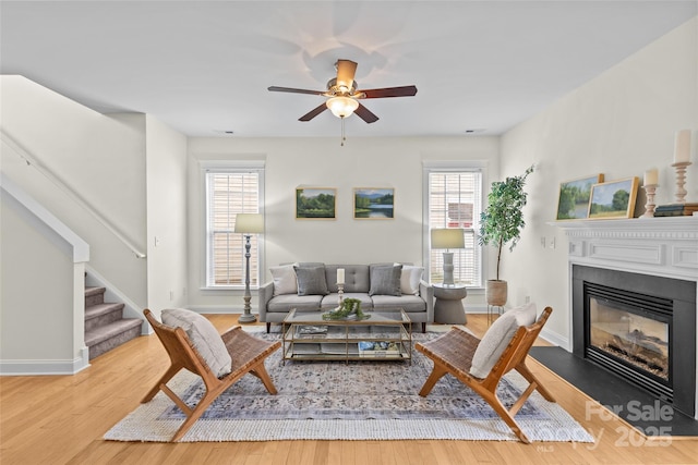 living room featuring hardwood / wood-style flooring and ceiling fan