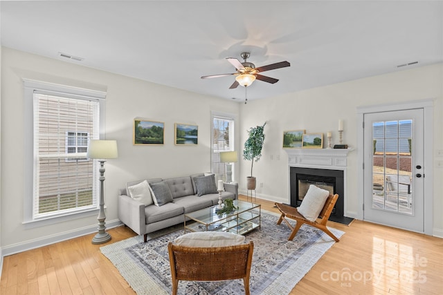 living room featuring ceiling fan and light hardwood / wood-style floors