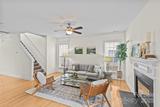 living room featuring hardwood / wood-style floors and ceiling fan