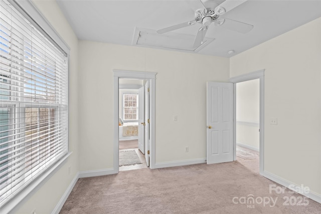 unfurnished bedroom featuring ensuite bath, light colored carpet, and ceiling fan