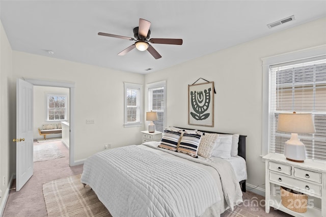 bedroom featuring light carpet and ceiling fan