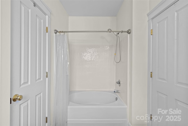 bathroom with shower / bath combo with shower curtain