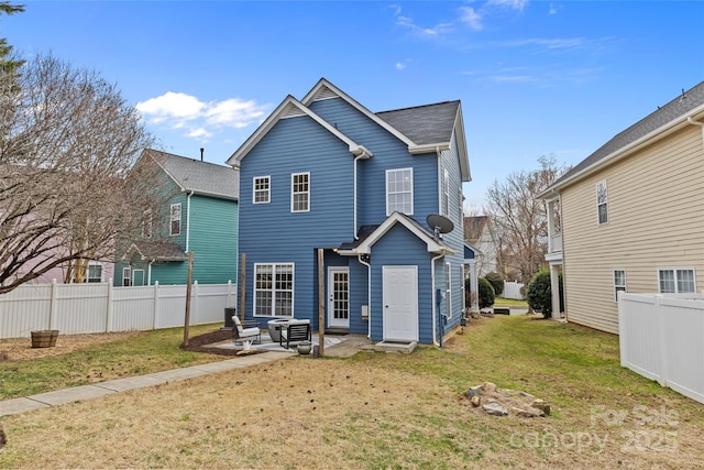 rear view of property with a yard and a patio area