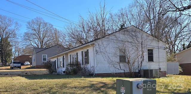 view of home's exterior with a lawn and central air condition unit