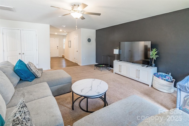 living room with carpet floors and ceiling fan