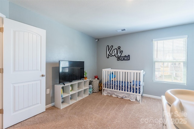 bedroom with carpet flooring and a crib