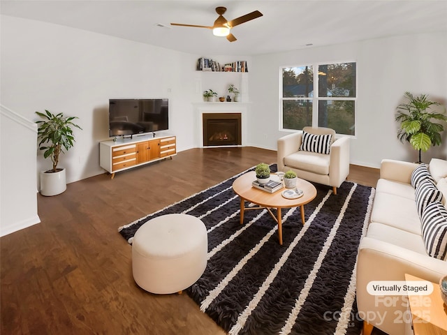 living room with ceiling fan and dark hardwood / wood-style floors