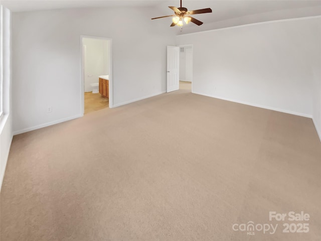 carpeted empty room with ceiling fan and vaulted ceiling