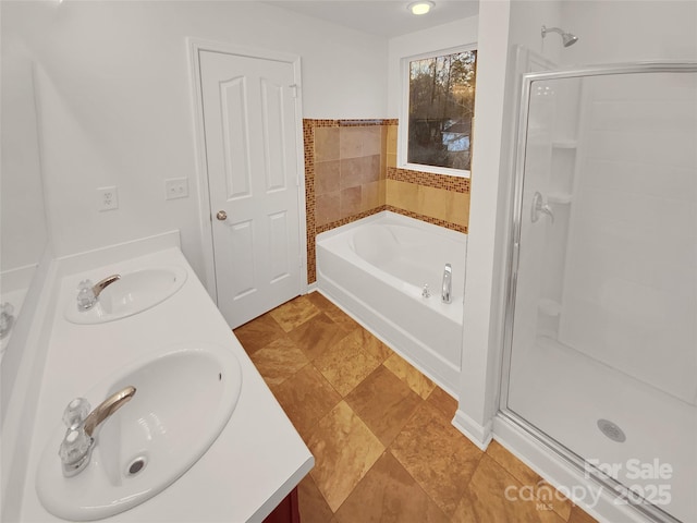 bathroom featuring vanity and separate shower and tub