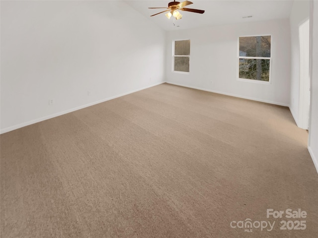 carpeted empty room featuring vaulted ceiling and ceiling fan