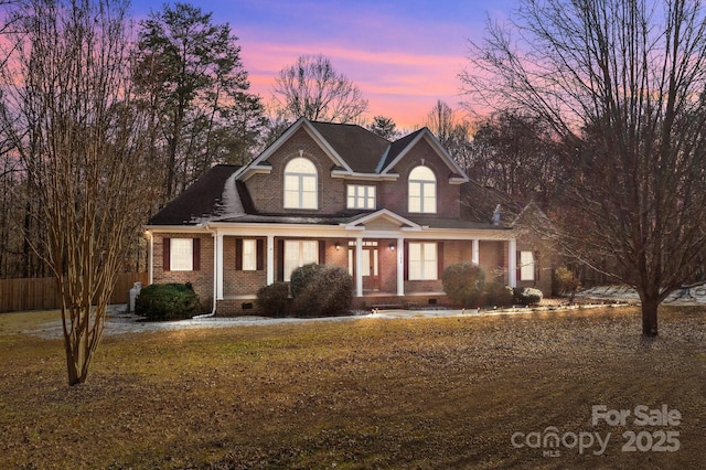 view of front of house featuring a yard and covered porch