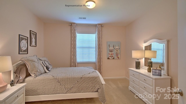 bedroom featuring visible vents, baseboards, and light colored carpet