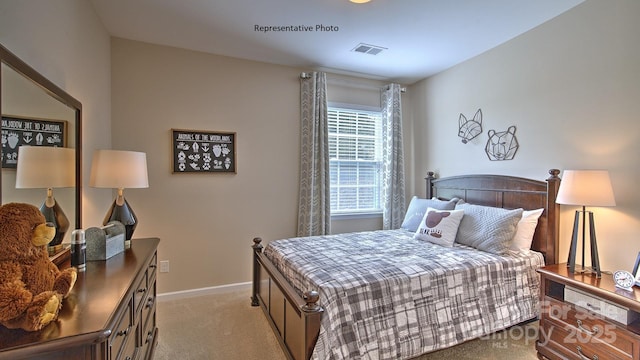 bedroom with baseboards, visible vents, and light carpet