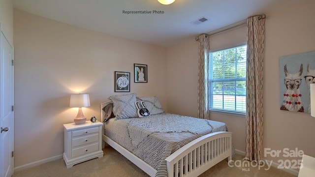 bedroom featuring visible vents, baseboards, and light colored carpet