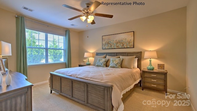 bedroom with ceiling fan, light colored carpet, visible vents, and baseboards