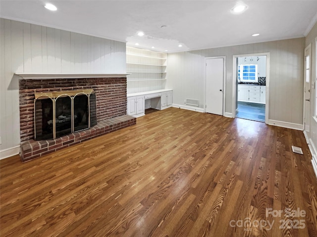 unfurnished living room with hardwood / wood-style flooring and a fireplace