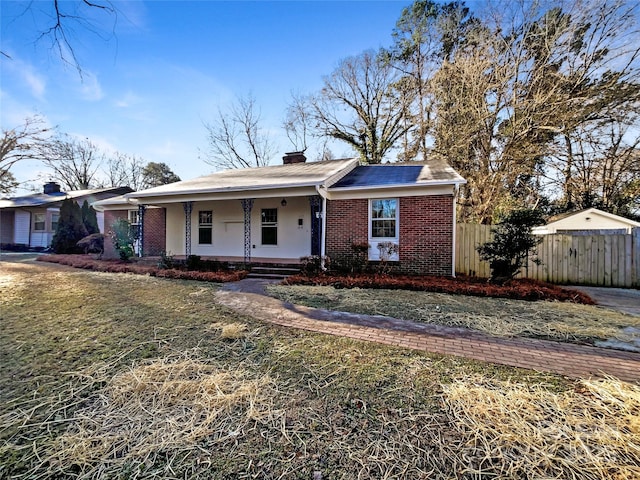 view of front of home featuring covered porch and a front yard