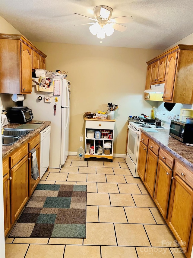 kitchen featuring sink, white appliances, a textured ceiling, light tile patterned floors, and ceiling fan