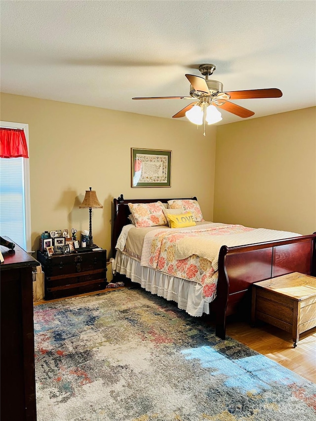 bedroom with ceiling fan and hardwood / wood-style floors