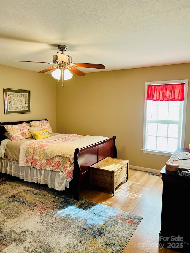 bedroom featuring hardwood / wood-style floors and ceiling fan