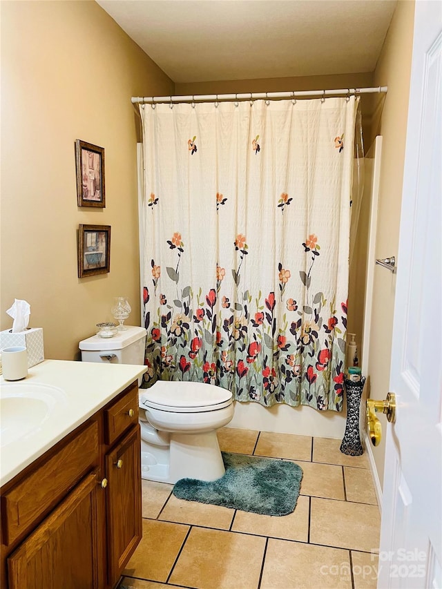 bathroom with tile patterned flooring, vanity, and toilet