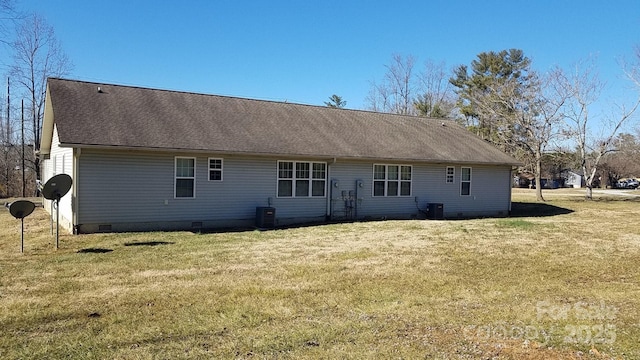 back of property featuring cooling unit and a lawn