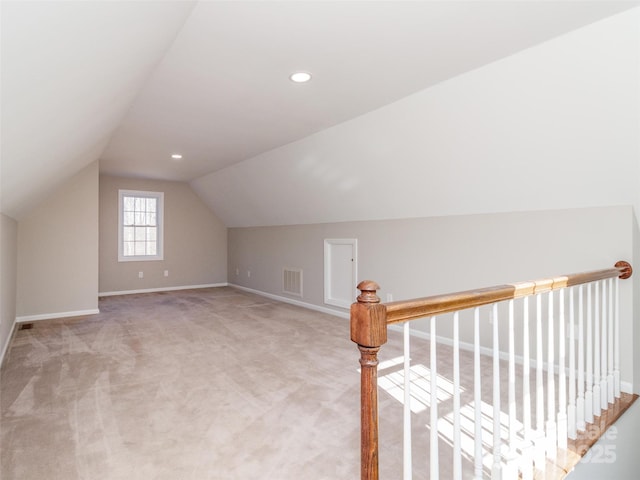 additional living space with lofted ceiling and light carpet