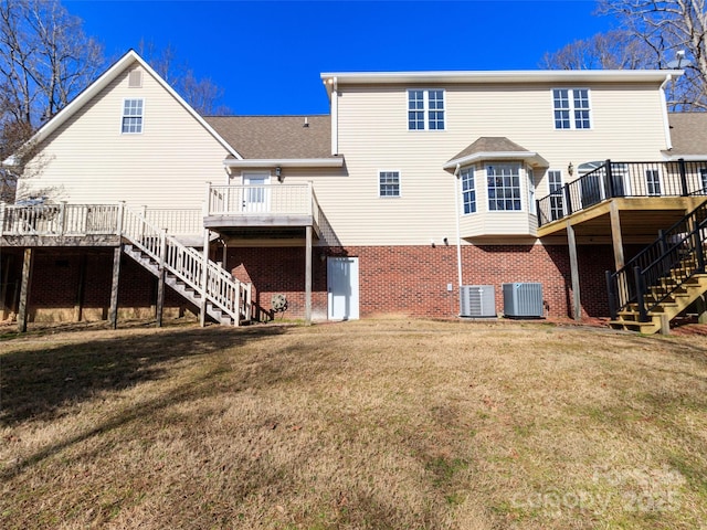 back of property with central AC unit, a yard, and a deck