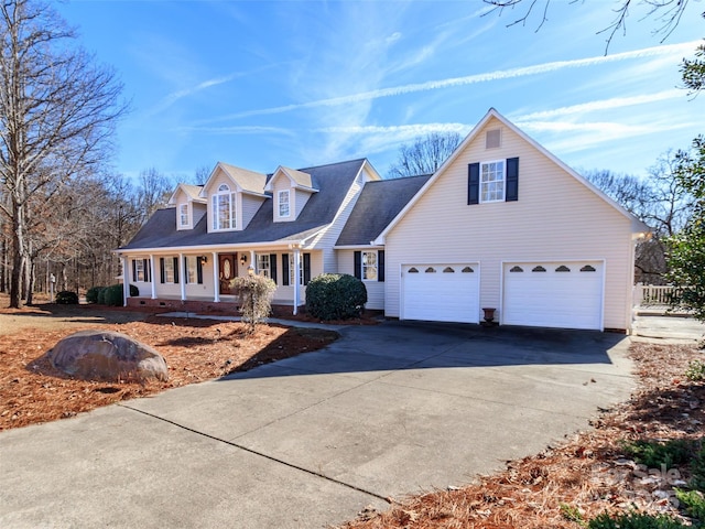 new england style home with a garage and covered porch