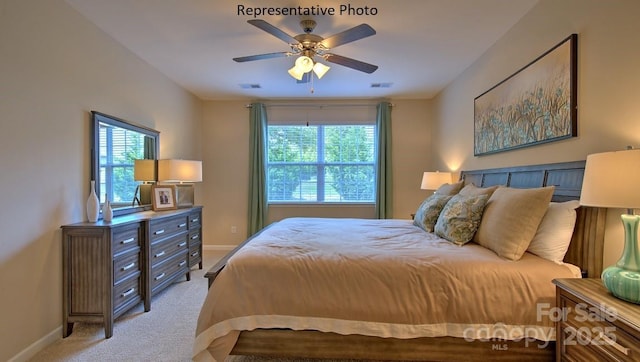 bedroom featuring multiple windows, light colored carpet, and ceiling fan