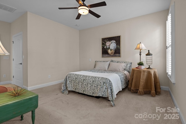 carpeted bedroom featuring baseboards, visible vents, and ceiling fan