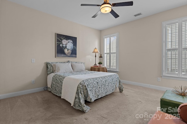 bedroom with carpet floors, visible vents, baseboards, and ceiling fan