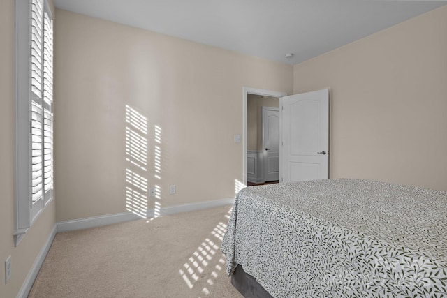 carpeted bedroom featuring baseboards