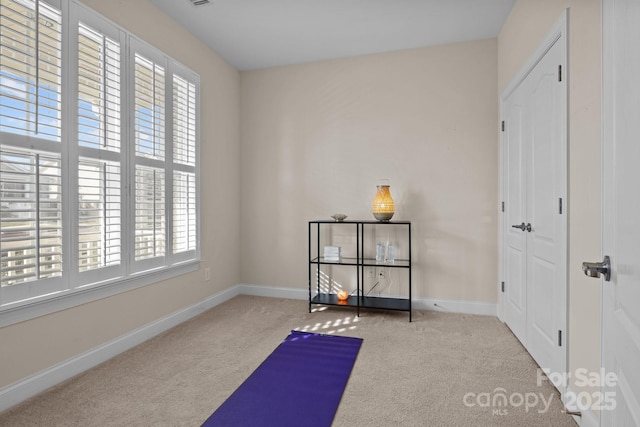 workout area with carpet and baseboards