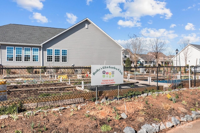 view of side of property featuring fence and a residential view