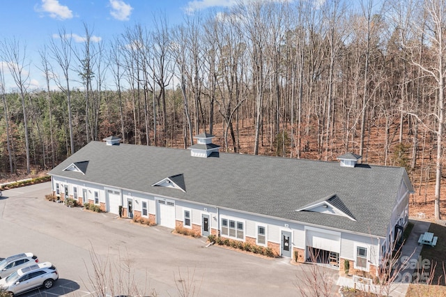 exterior space featuring a wooded view