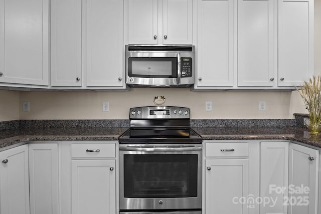 kitchen with stainless steel appliances and white cabinetry