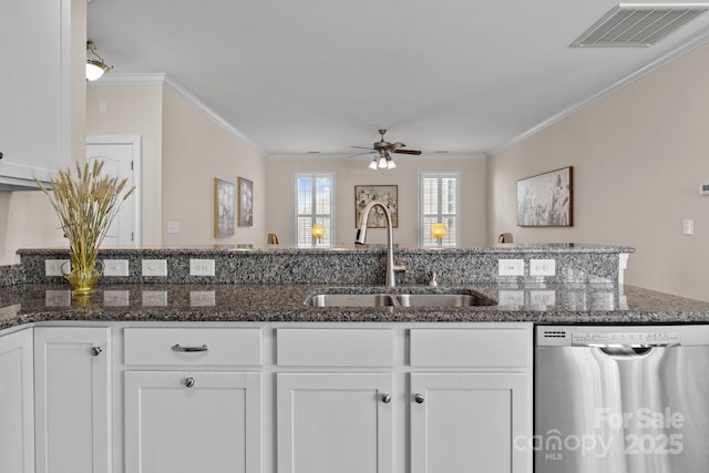 kitchen with stainless steel dishwasher, a sink, visible vents, and white cabinets