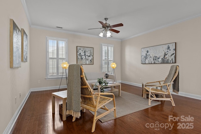 living area with wood finished floors, visible vents, baseboards, a ceiling fan, and crown molding