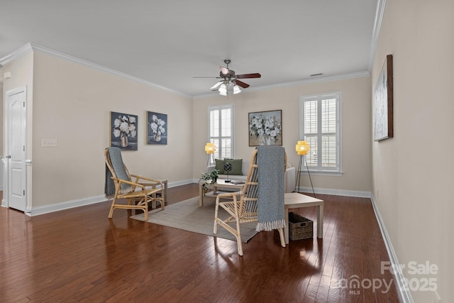 sitting room featuring wood-type flooring, crown molding, and baseboards