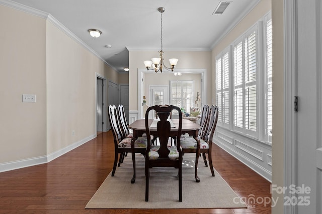 dining area with a wealth of natural light, visible vents, and wood finished floors