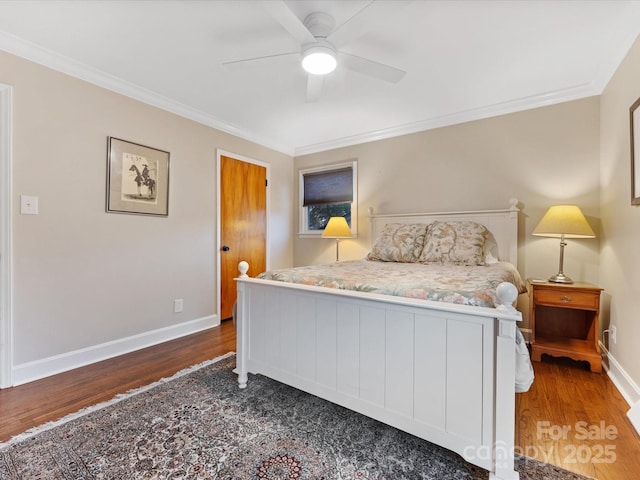 bedroom with crown molding, dark hardwood / wood-style floors, and ceiling fan